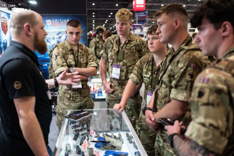 LONDON, ENGLAND - SEPTEMBER 15: Members of the armed forces speak with a member of a laser sight company sales team on day two of the DSEI (Defence and Security Equipment International) exhibition at ExCel on أيلول 15, 2021 in London, England. The four day event sees over 1,000 defence, technology and security manufacturers display their latest developments to Governments and security companies from around the world. (Photo by Leon Neal/Getty Images) (Photo by Leon Neal/Getty Images)