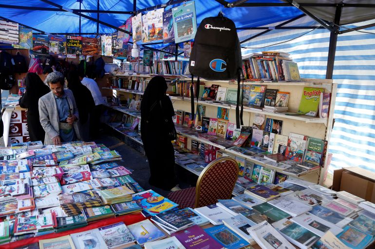 SANA'A, YEMEN - SEPTEMBER 26: Yemenis visit the book fair opened as an opportunity to enable people to buy books with reduced prices during the continued economic crisis, on أيلول 26, 2021 in Sana'a, Yemen. Book Fair in Sana'a is in dire straits owing to a lack of customers during the six days it has been because of the severe economic crisis of people following the nearly seven years of war and blockade that left 80% of the country's 28-million population in need of assistance and pushed most of them only to focus on how they can feed their children. Only a handful of visitors came to the fair and most of them did not even buy books but left after only reading the books while standing beside its shelves. Despite the fair opening that was planned to enable reading enthusiasts and university students who were affected by the continued crisis greatly, to be able to buy books they need at discount prices, but it seems that most Yemenis look on basic daily needs like food and water more than anything else. (Photo by Mohammed Hamoud/Getty Images)