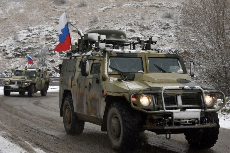 Military vehicles of the Russian peacekeeping force move on the road outside Lachin on تشرين الثاني 29, 2020, after six weeks of fighting between Armenia and Azerbaijan over the disputed Nagorno-Karabakh region. - A Moscow-brokered peace deal was announced on تشرين الثاني 10 after Azerbaijan's military overwhelmed Armenian separatist forces and threatened to advance on Karabakh's main city Stepanakert. (Photo by Karen MINASYAN / AFP) (Photo by KAREN MINASYAN/AFP via Getty Images)
