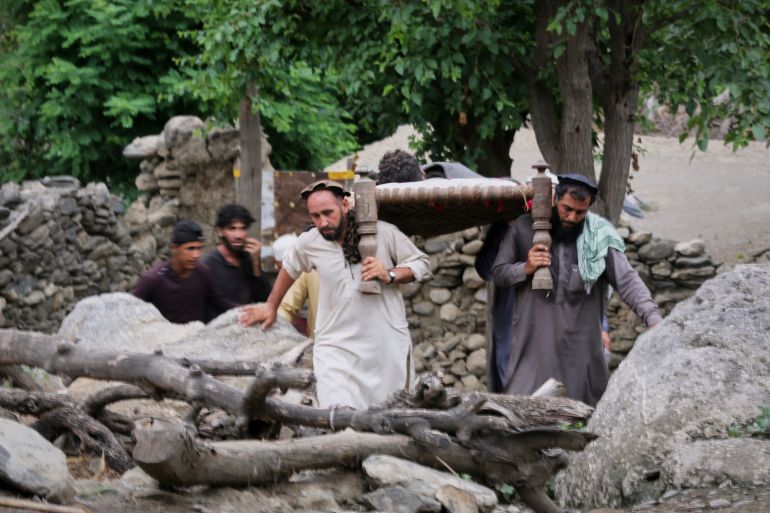 An injured person is carried to a military helicopter that landed to evacuate injured victims of an earthquake that killed many people and destroyed villages in eastern Afghanistan, in Mazar Dara, Kunar province, Monday, Sept. 1, 2025. (AP Photo/Wahidullah Kakar)