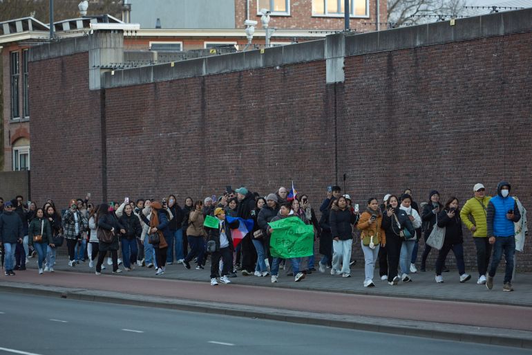 THE HAGUE, NETHERLANDS - MARCH 12: Supporters of ex-leader of the Philippines Rodrigo Duterte living in The Netherlands and Belgium gather outside The Hague Penitentiary Institution, which includes a special independently operating unit at its Scheveningen location and houses the United Nations Detention Unit (UNDU), a UN-administered facility within the prison, on آذار 12, 2025 in The Hague, Netherlands. Former Philippine President Rodrigo Duterte was arrested this week in Manila on an International Criminal Court (ICC) warrant for crimes against humanity linked to thousands of deaths over his brutal anti-drug campaign. He is expected to be detained in the Hague, where the ICC is based. (Photo by Pierre Crom/Getty Images)