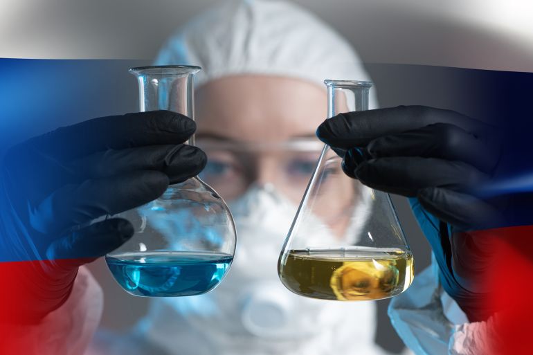A scientist on the background of the Russian flag. Scientific research in Russia. A woman sets up a scientific experiment. A researcher in a protective suit. A scientist with two flasks in his hands.